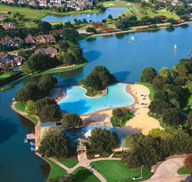 an aerial view of a house with a yard and lake view