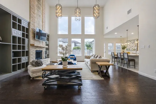 a living room with fireplace furniture and a large window