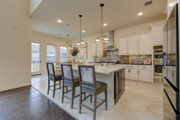 a kitchen with kitchen island granite countertop wooden cabinets and white appliances