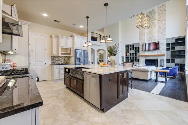 a kitchen with stainless steel appliances granite countertop a stove and a refrigerator