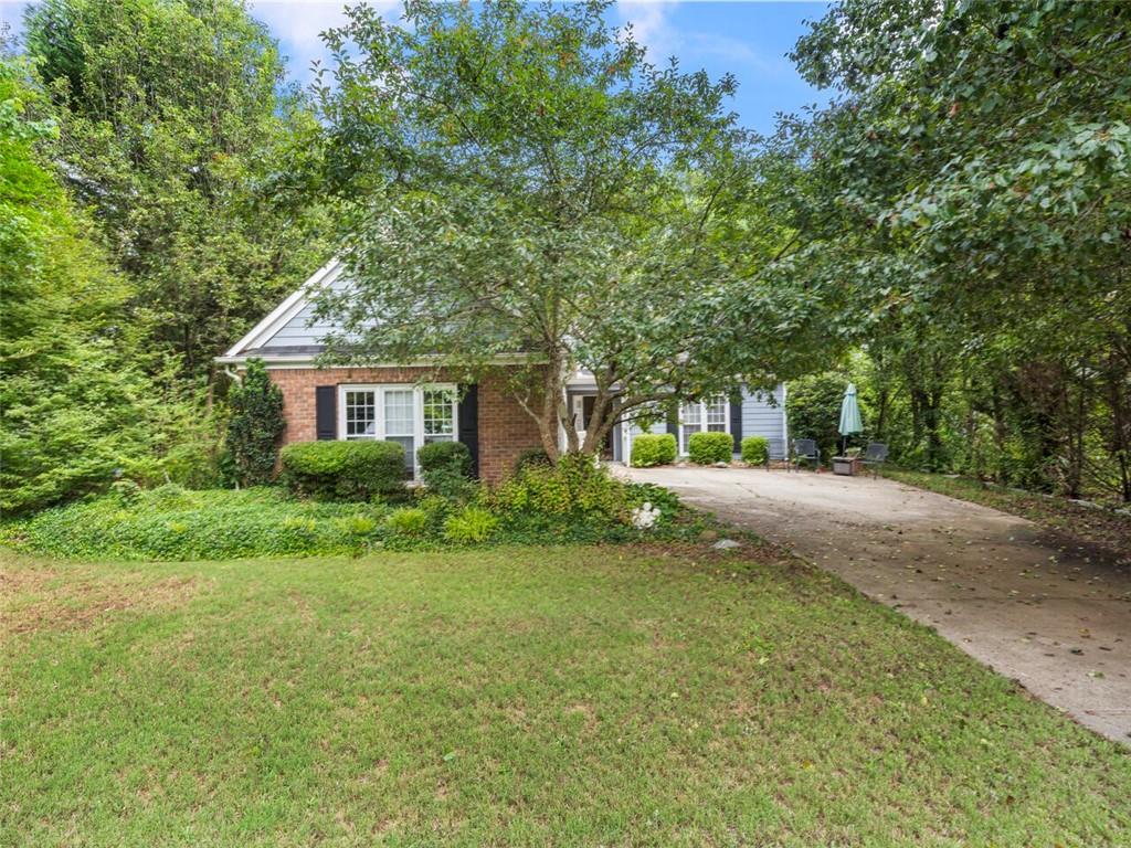 a view of house with yard and green space
