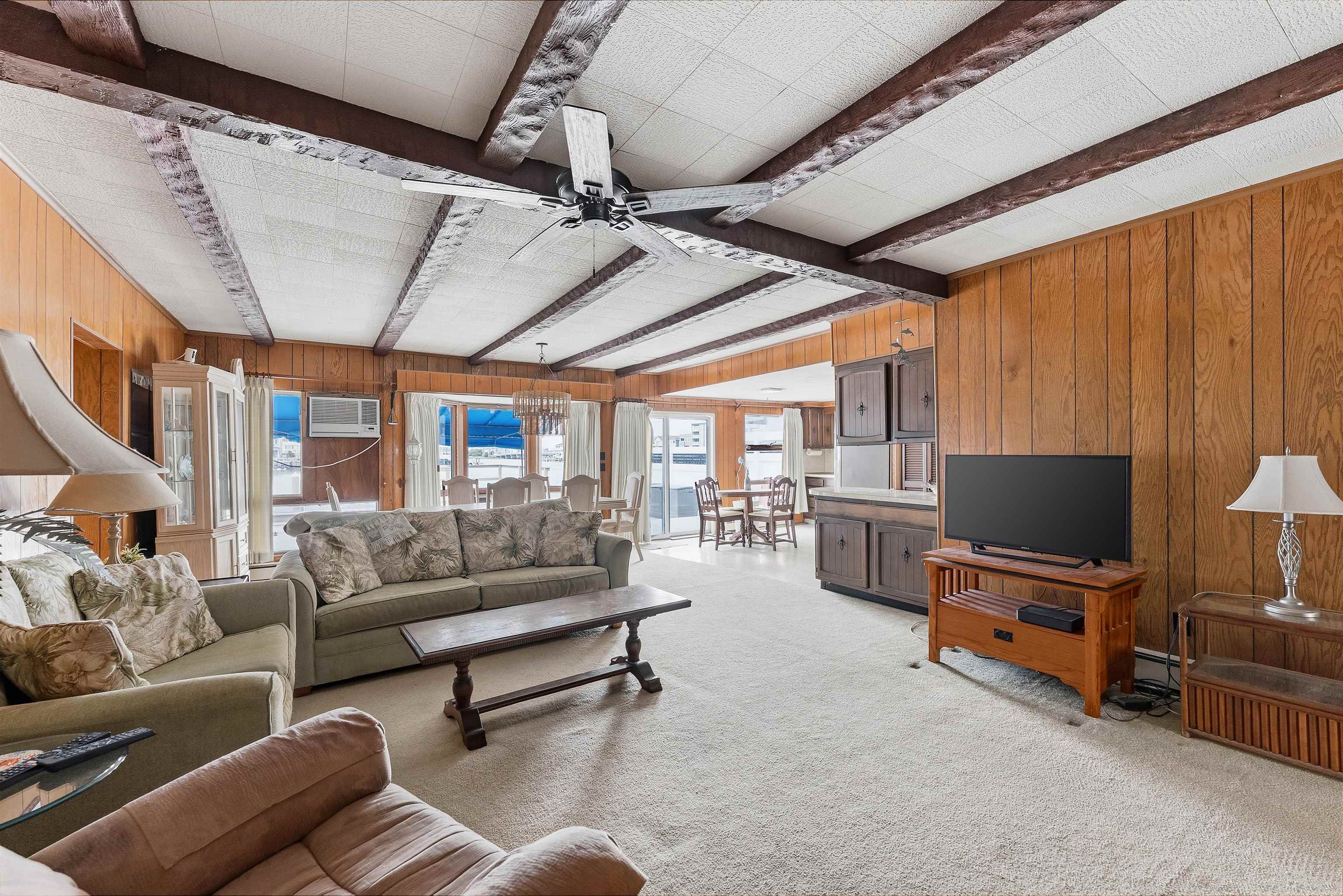 9727 3rd, Unit A1 Stone Harbor, NJ 08247 - Photo 17 of 20 a living room with furniture and a flat screen tv