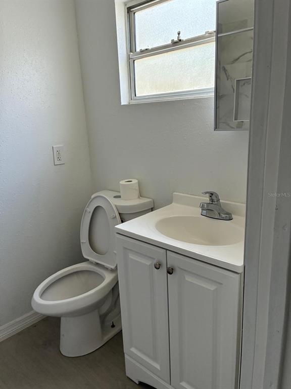 1008 Nebraska Street Leesburg, FL 34748 - Photo 12 of 26 a bathroom with a toilet sink and mirror