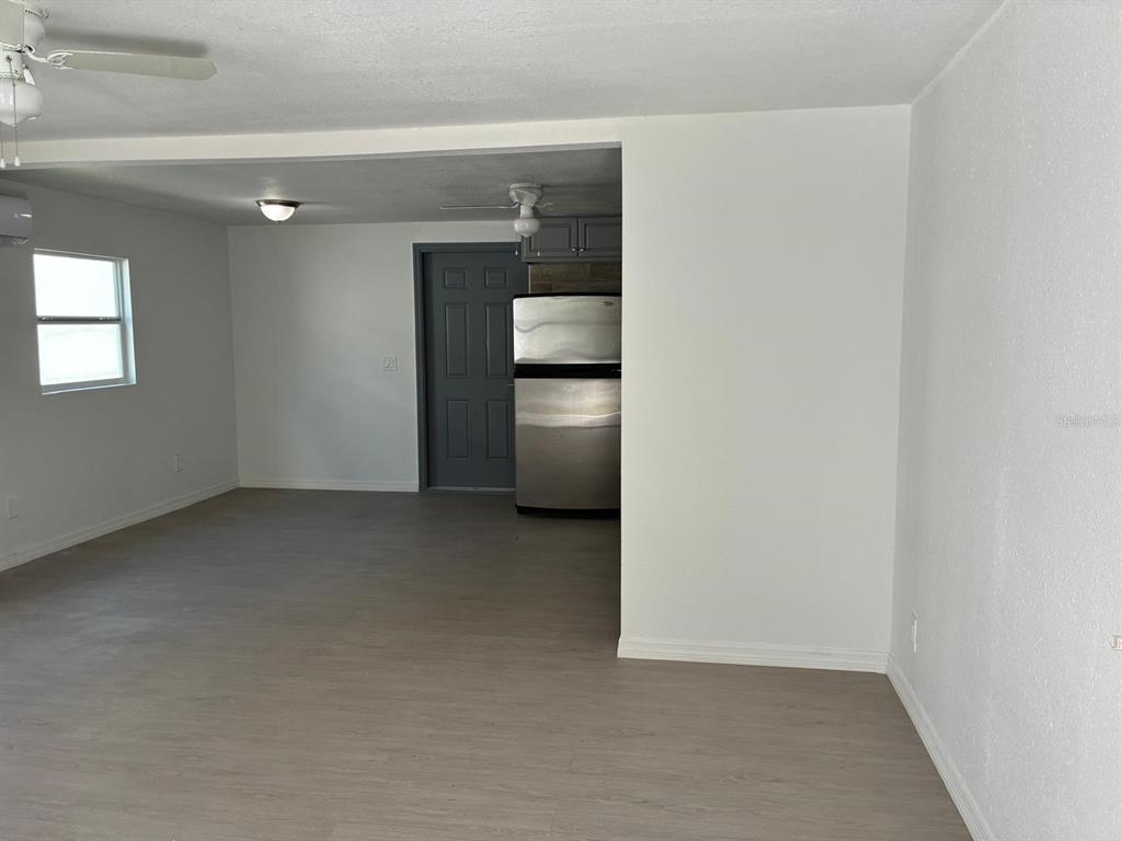 1008 Nebraska Street Leesburg, FL 34748 - Photo 2 of 26 an empty room with a kitchen space and a sink