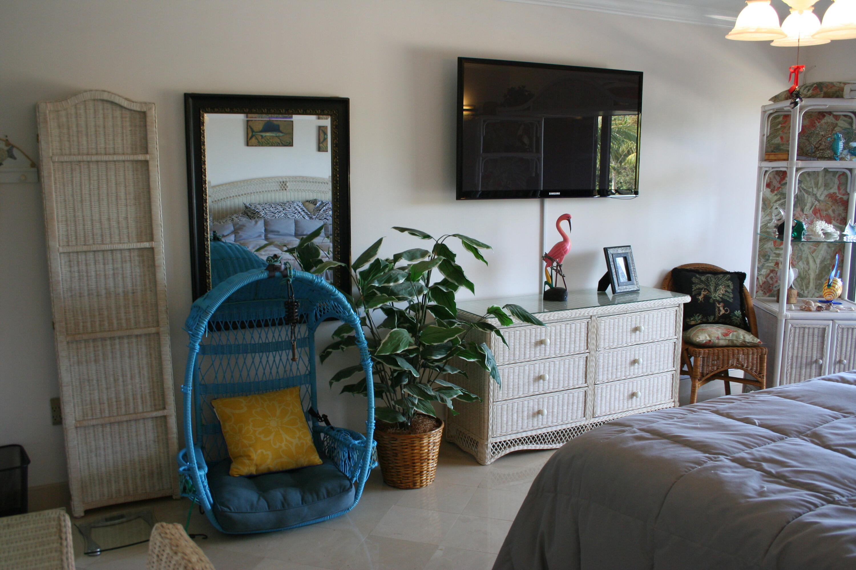 104500 Overseas Highway, Unit A302 Key Largo, FL 33037 - Photo 12 of 35 a bedroom with a bed a flat screen tv and dresser