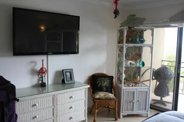 a view of swimming pool with a table and chairs under an umbrella