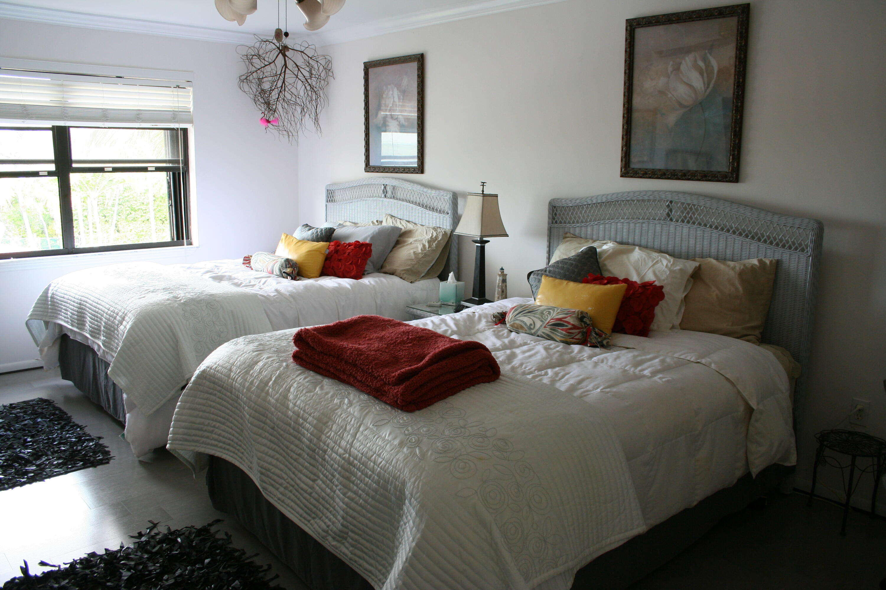 104500 Overseas Highway, Unit A302 Key Largo, FL 33037 - Photo 17 of 35 a bedroom with a bed and a chandelier