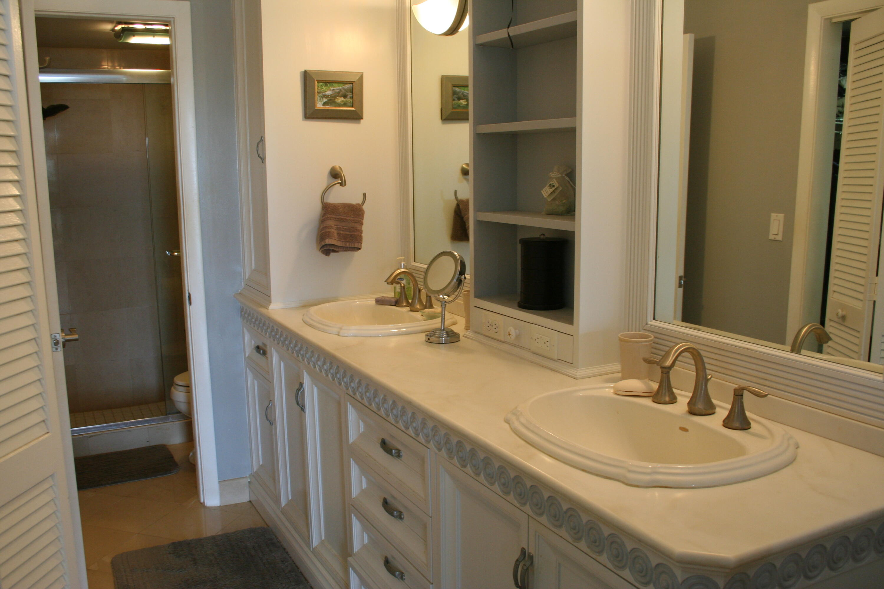 104500 Overseas Highway, Unit A302 Key Largo, FL 33037 - Photo 19 of 35 a bathroom with a sink and a mirror