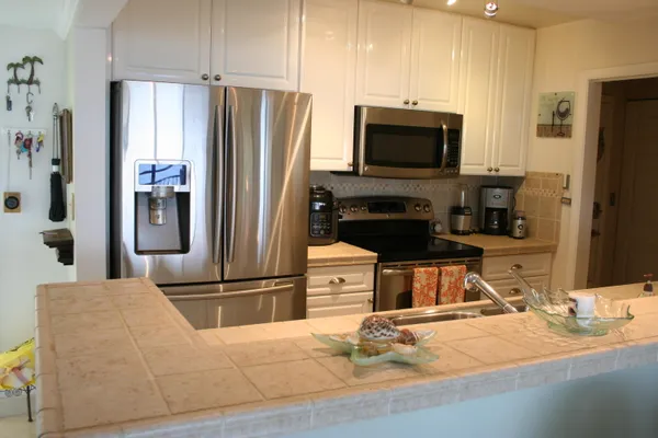 a kitchen with a sink and a stove top oven