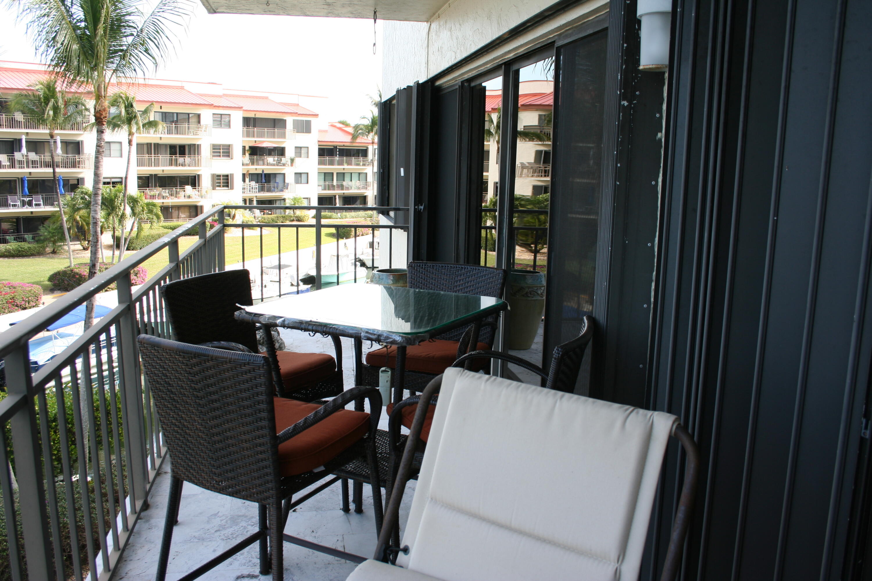 104500 Overseas Highway, Unit A302 Key Largo, FL 33037 - Photo 23 of 35 a view of a chairs and table in a balcony