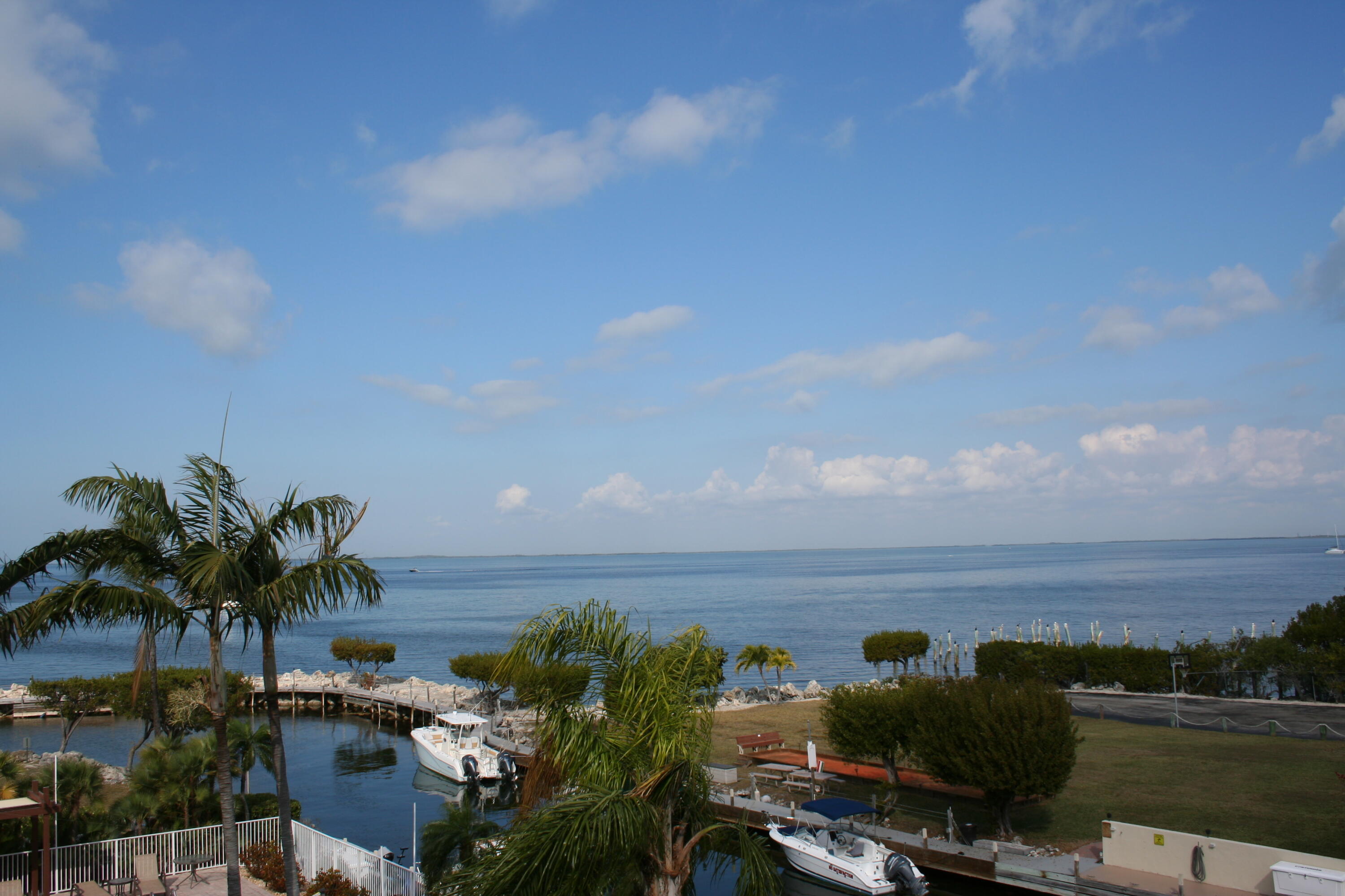 104500 Overseas Highway, Unit A302 Key Largo, FL 33037 - Photo 31 of 35 a view of a lake with a city