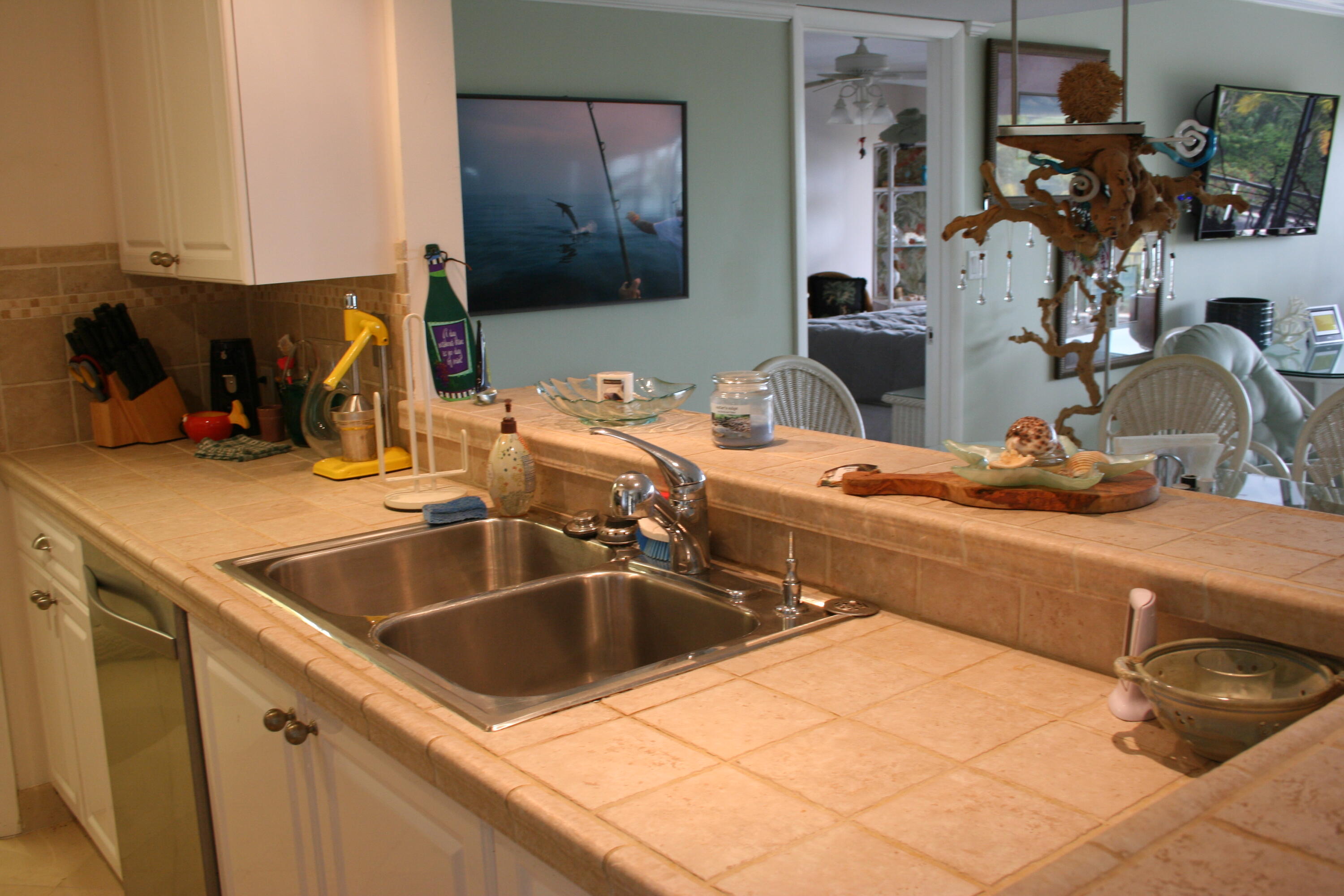 104500 Overseas Highway, Unit A302 Key Largo, FL 33037 - Photo 5 of 35 a kitchen with a sink and a stove top oven
