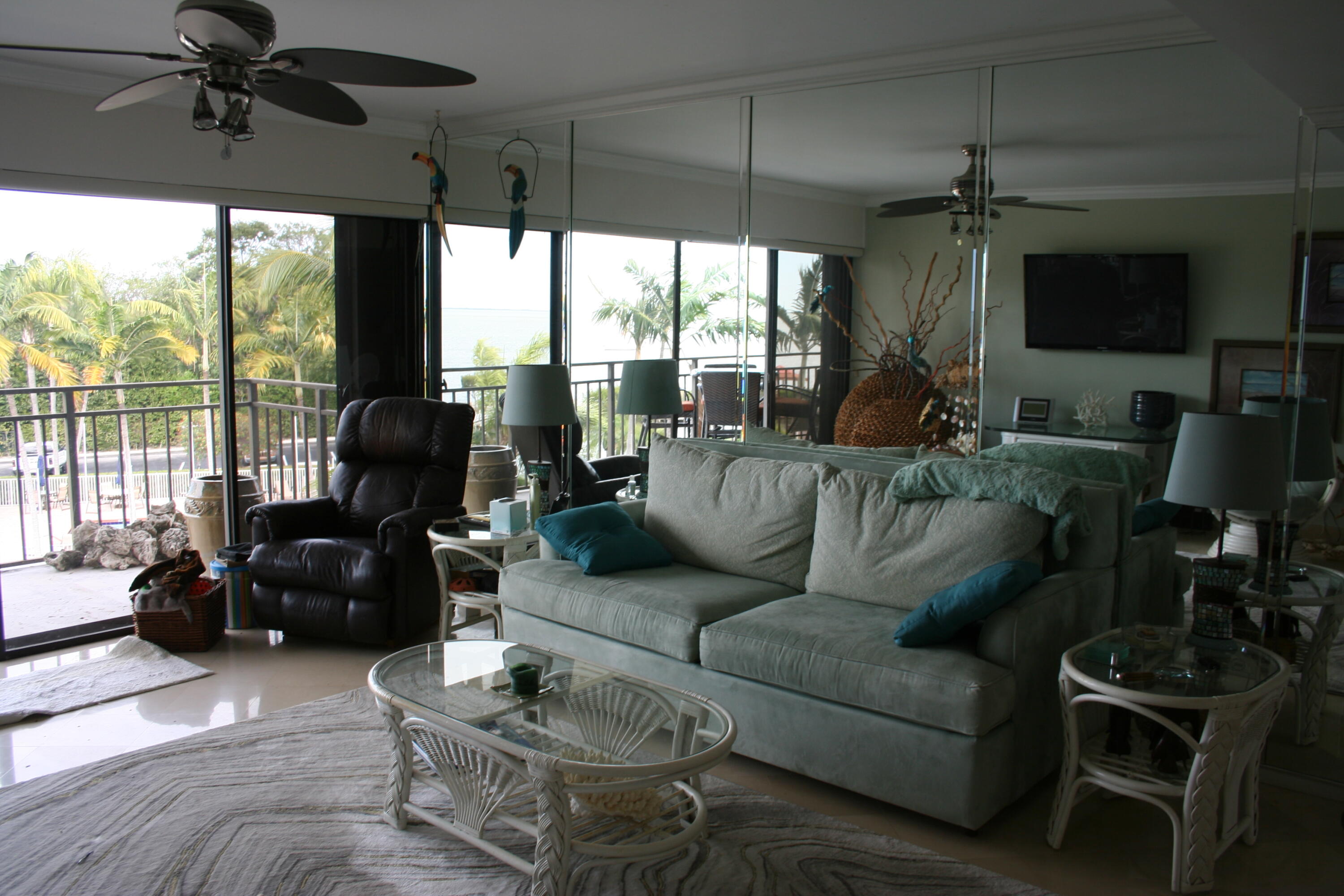 104500 Overseas Highway, Unit A302 Key Largo, FL 33037 - Photo 9 of 35 a living room with furniture and a flat screen tv