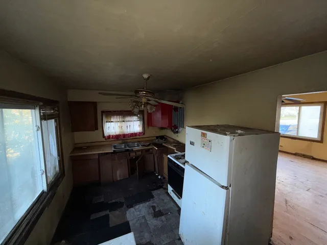a kitchen with a refrigerator and a stove