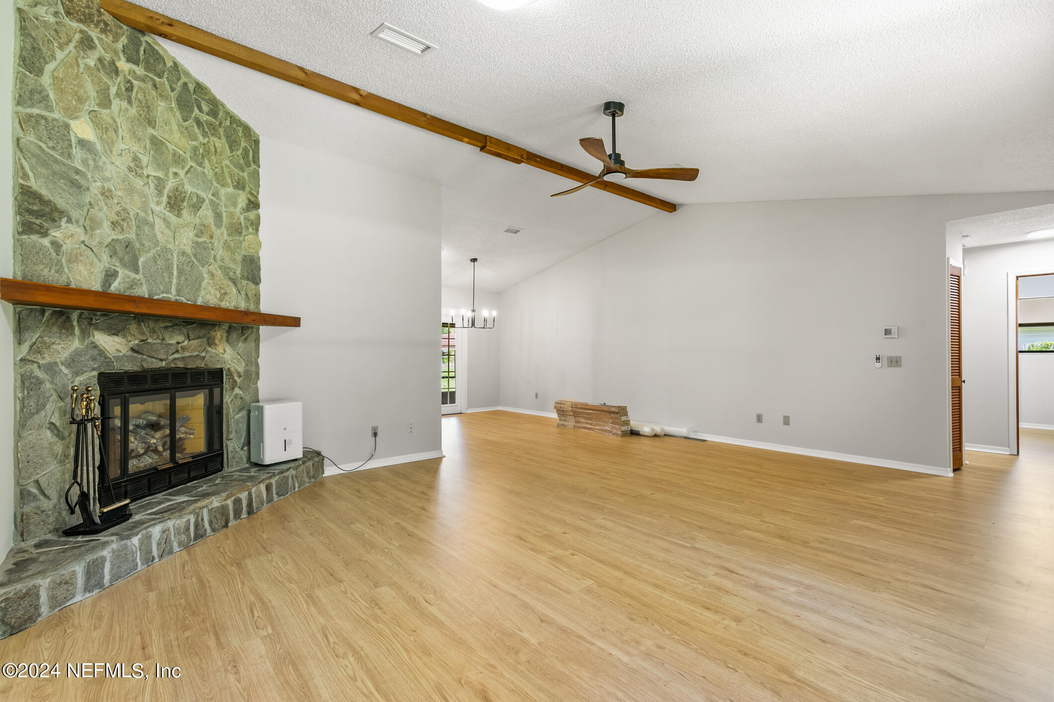 5165 Datil Pepper Road St. Augustine, FL 32086 - Photo 14 of 54 a view of empty room with wooden floor and fireplace