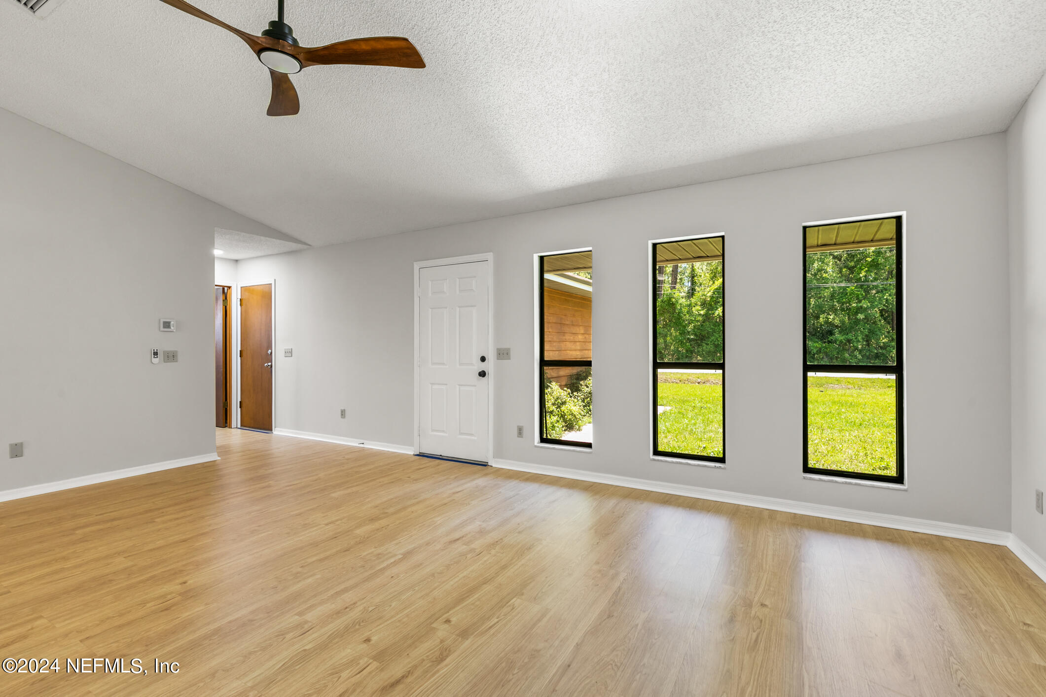 5165 Datil Pepper Road St. Augustine, FL 32086 - Photo 16 of 54 a view of an empty room with window and wooden floor