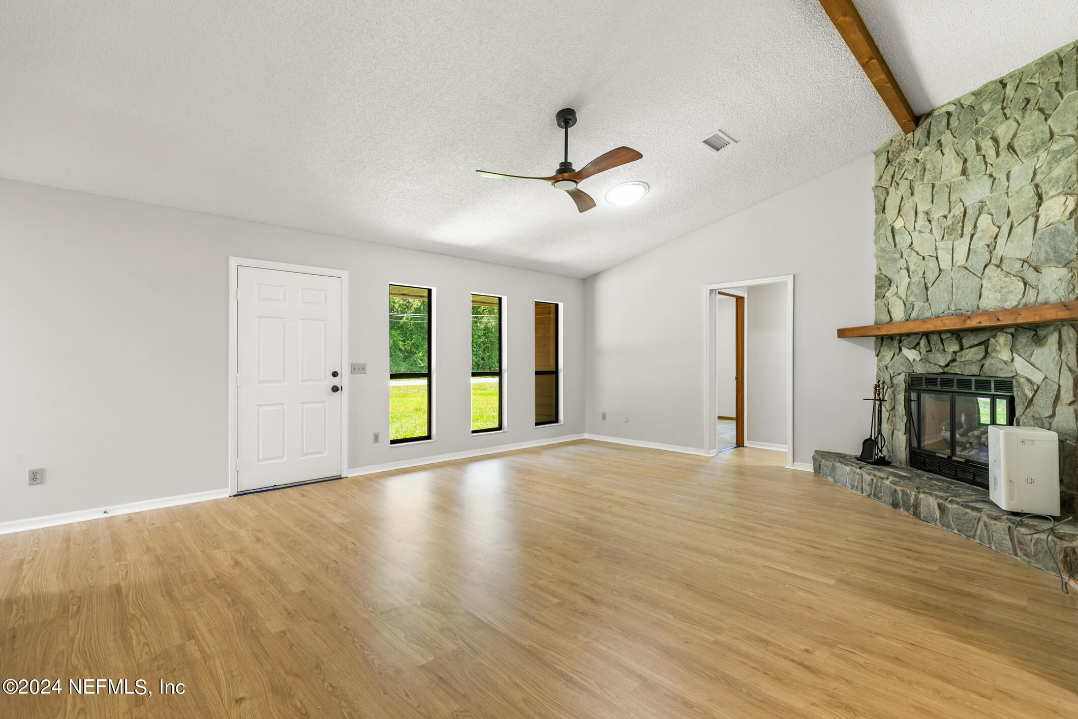 5165 Datil Pepper Road St. Augustine, FL 32086 - Photo 17 of 54 a view of an empty room with wooden floor and a window