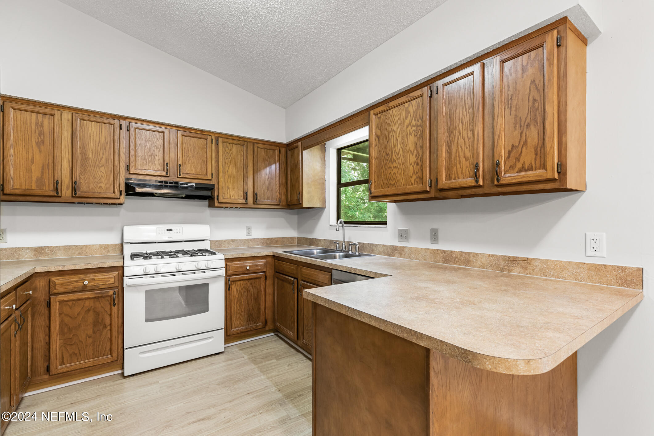 5165 Datil Pepper Road St. Augustine, FL 32086 - Photo 22 of 54 a kitchen with stainless steel appliances granite countertop a stove a sink and a microwave