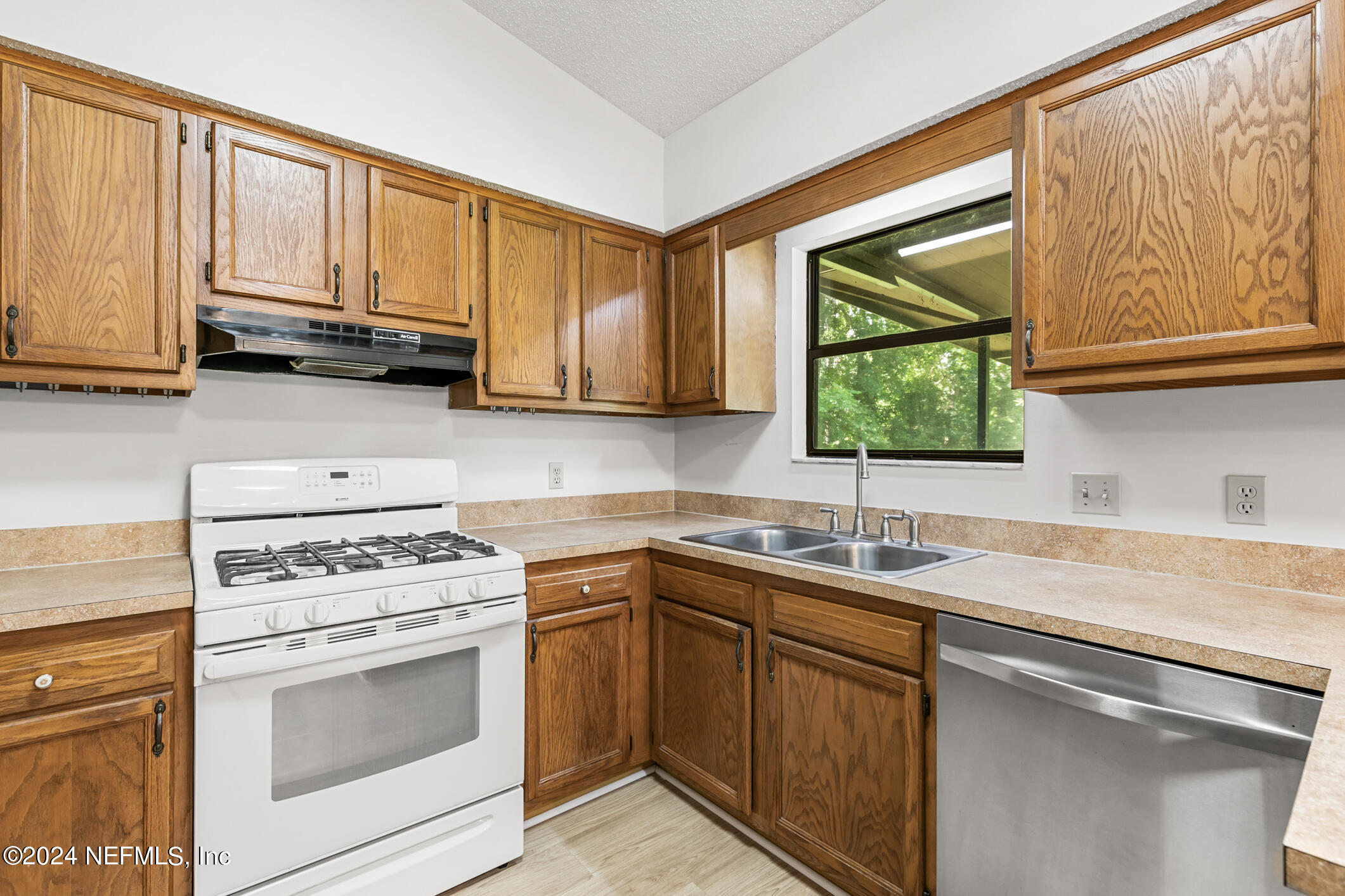 5165 Datil Pepper Road St. Augustine, FL 32086 - Photo 23 of 54 a kitchen with stainless steel appliances granite countertop a sink a stove and cabinets