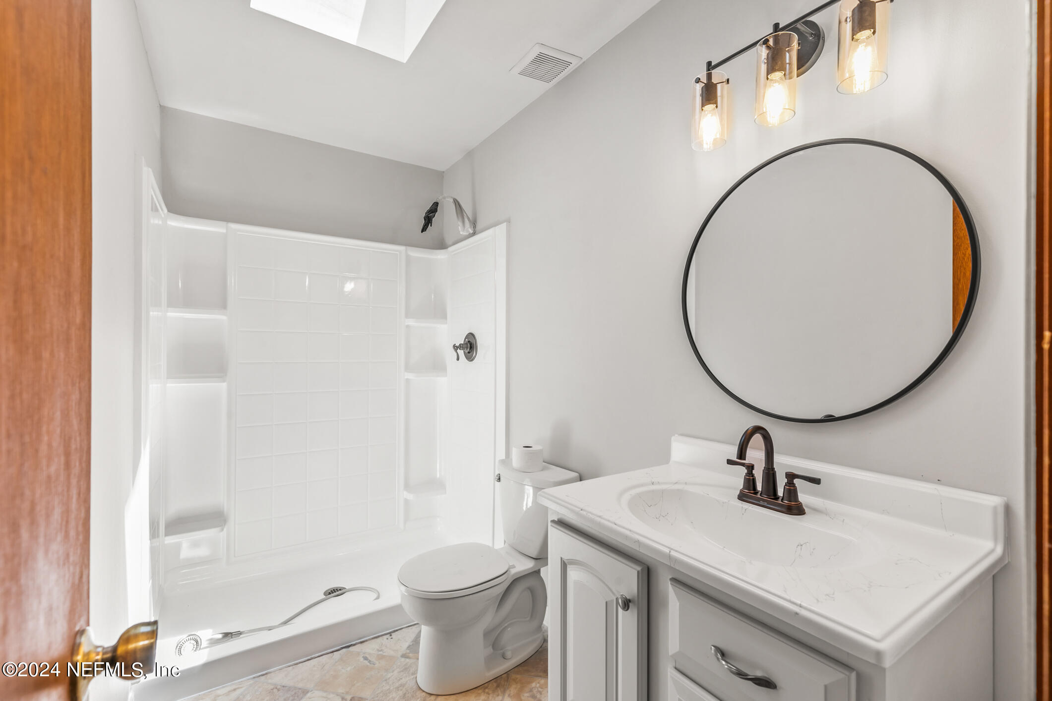 5165 Datil Pepper Road St. Augustine, FL 32086 - Photo 32 of 54 a bathroom with a sink a toilet and a mirror