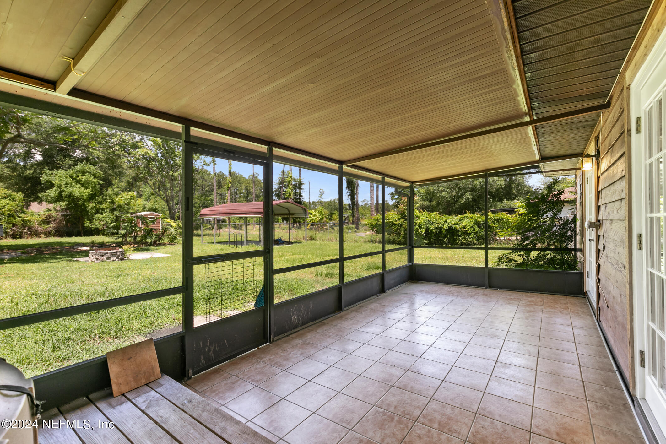 5165 Datil Pepper Road St. Augustine, FL 32086 - Photo 44 of 54 a view of a porch with wooden floor and bench