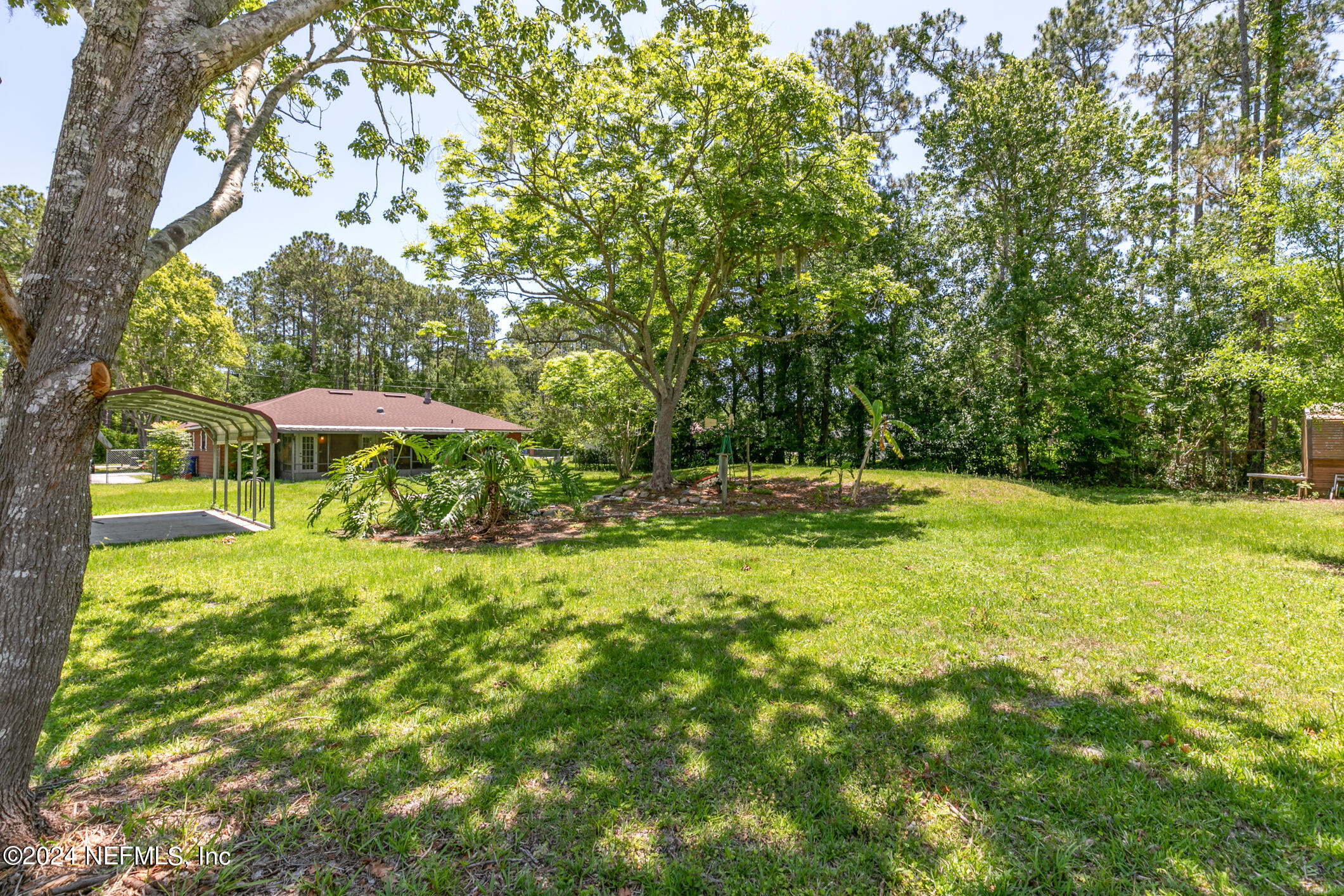 5165 Datil Pepper Road St. Augustine, FL 32086 - Photo 51 of 54 a backyard of a house with yard and outdoor seating