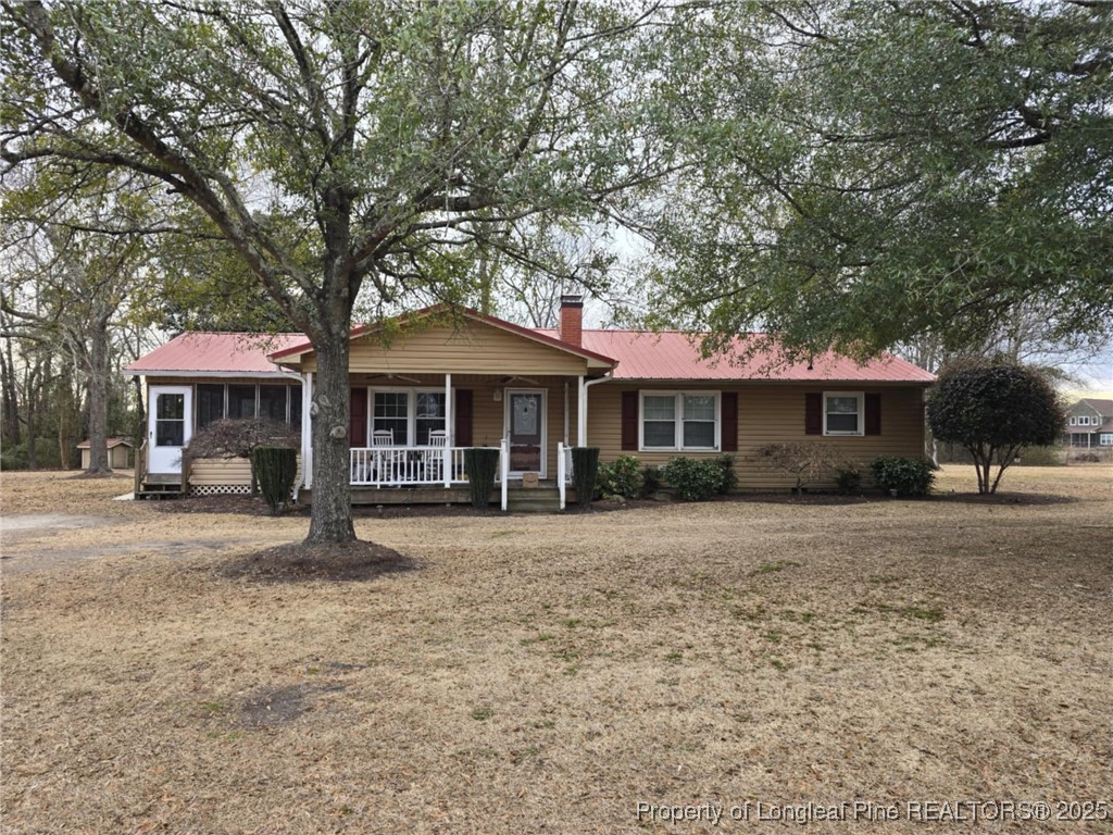 3114 School Road Hope Mills, NC 28348 - Photo 1 of 2 a front view of a house with a garden