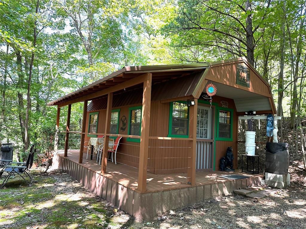 Super cute shed converted to cabin with covered porch