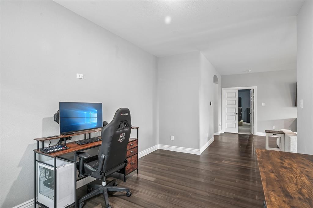 1805 Huntsman Way Forney, TX 75126 - Photo 20 of 34 Versatile room featuring dark wood-finish flooring, light-toned walls, and white baseboards