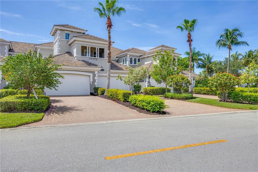 a front view of a house with a yard and a garage