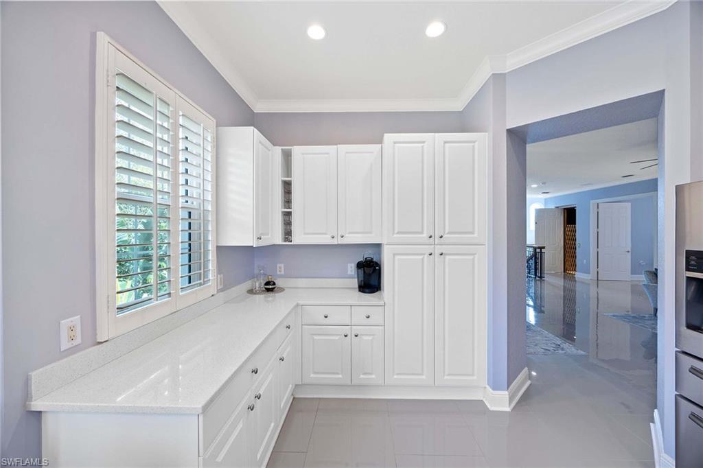 9202 Museo Circle, Unit 204 Naples, FL 34114 - Photo 14 of 37 a kitchen with white cabinets and white appliances