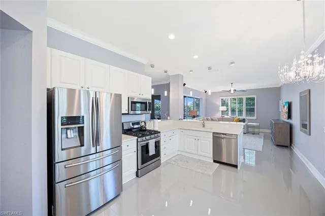 a kitchen with stainless steel appliances a refrigerator sink and stove