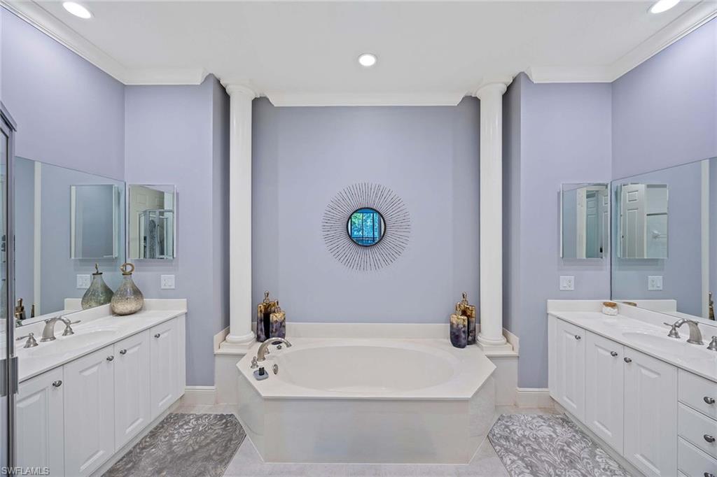 9202 Museo Circle, Unit 204 Naples, FL 34114 - Photo 20 of 37 a bathroom with a white tub shower vanity and a sink