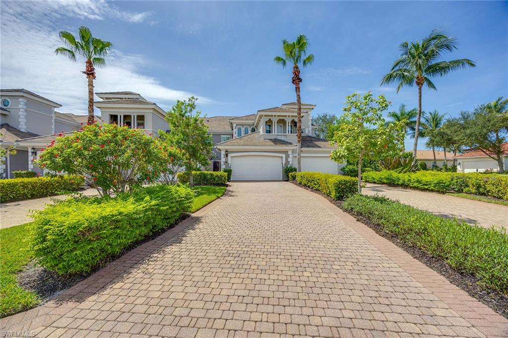 9202 Museo Circle, Unit 204 Naples, FL 34114 - Photo 2 of 37 a front view of a house with a yard and potted plants