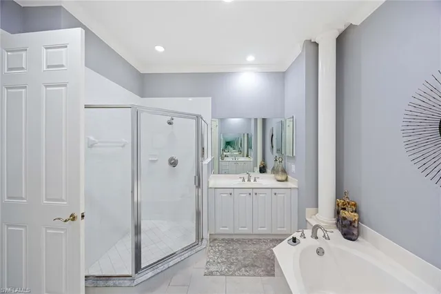 a bathroom with a bathtub a shower a sink and a window