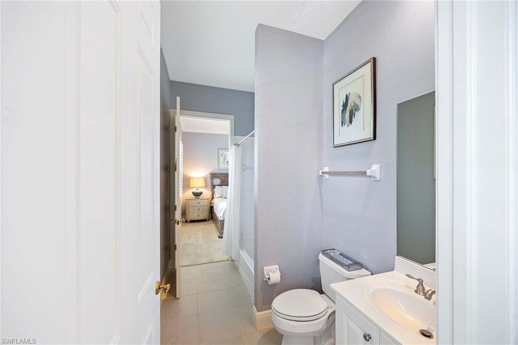 9202 Museo Circle, Unit 204 Naples, FL 34114 - Photo 25 of 37 a bathroom with a toilet sink and mirror