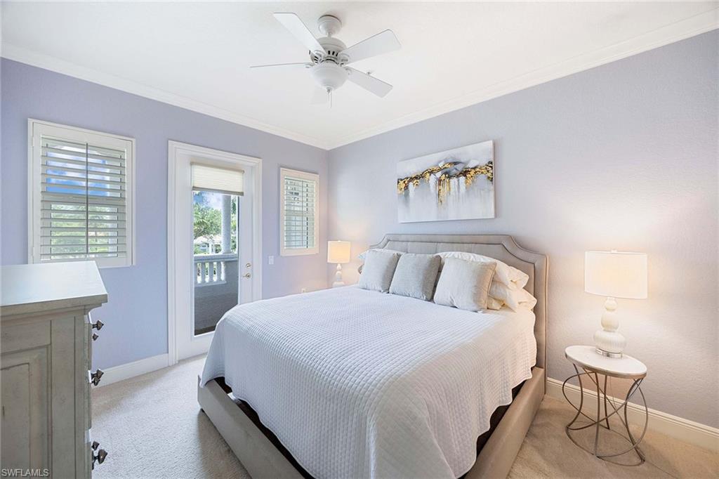 9202 Museo Circle, Unit 204 Naples, FL 34114 - Photo 27 of 37 a bedroom with a large bed and a chandelier