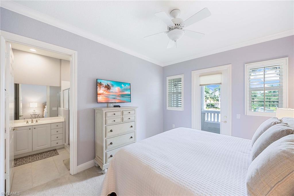 9202 Museo Circle, Unit 204 Naples, FL 34114 - Photo 28 of 37 a bedroom with a bed and a chandelier