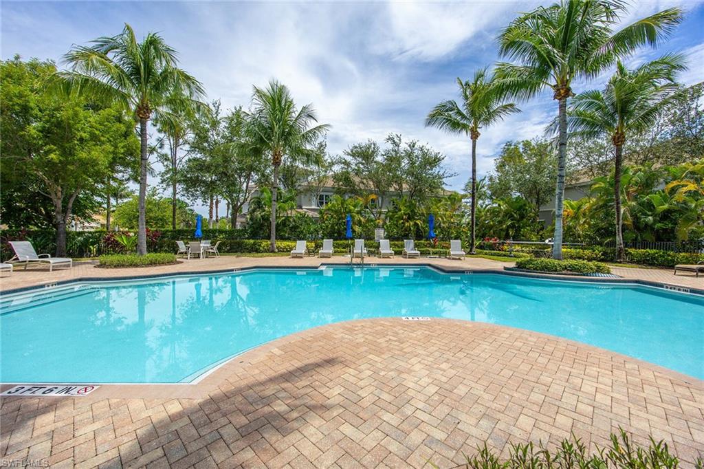 9202 Museo Circle, Unit 204 Naples, FL 34114 - Photo 34 of 37 a view of a swimming pool and trees in the background