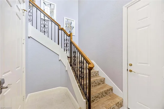 a view of staircase with wooden floor and white walls