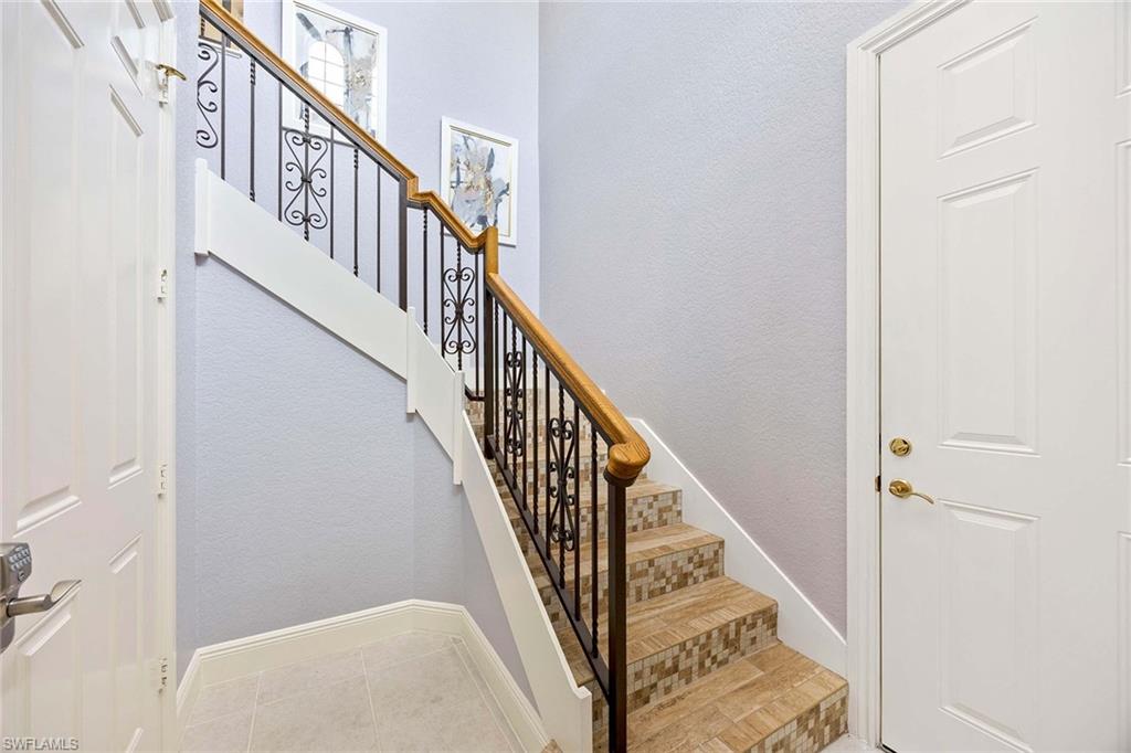 9202 Museo Circle, Unit 204 Naples, FL 34114 - Photo 4 of 37 a view of staircase with wooden floor and white walls