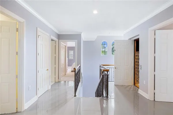 a view of hallway with furniture and wooden floor
