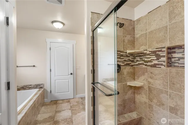 a bedroom with a bed and a lamp