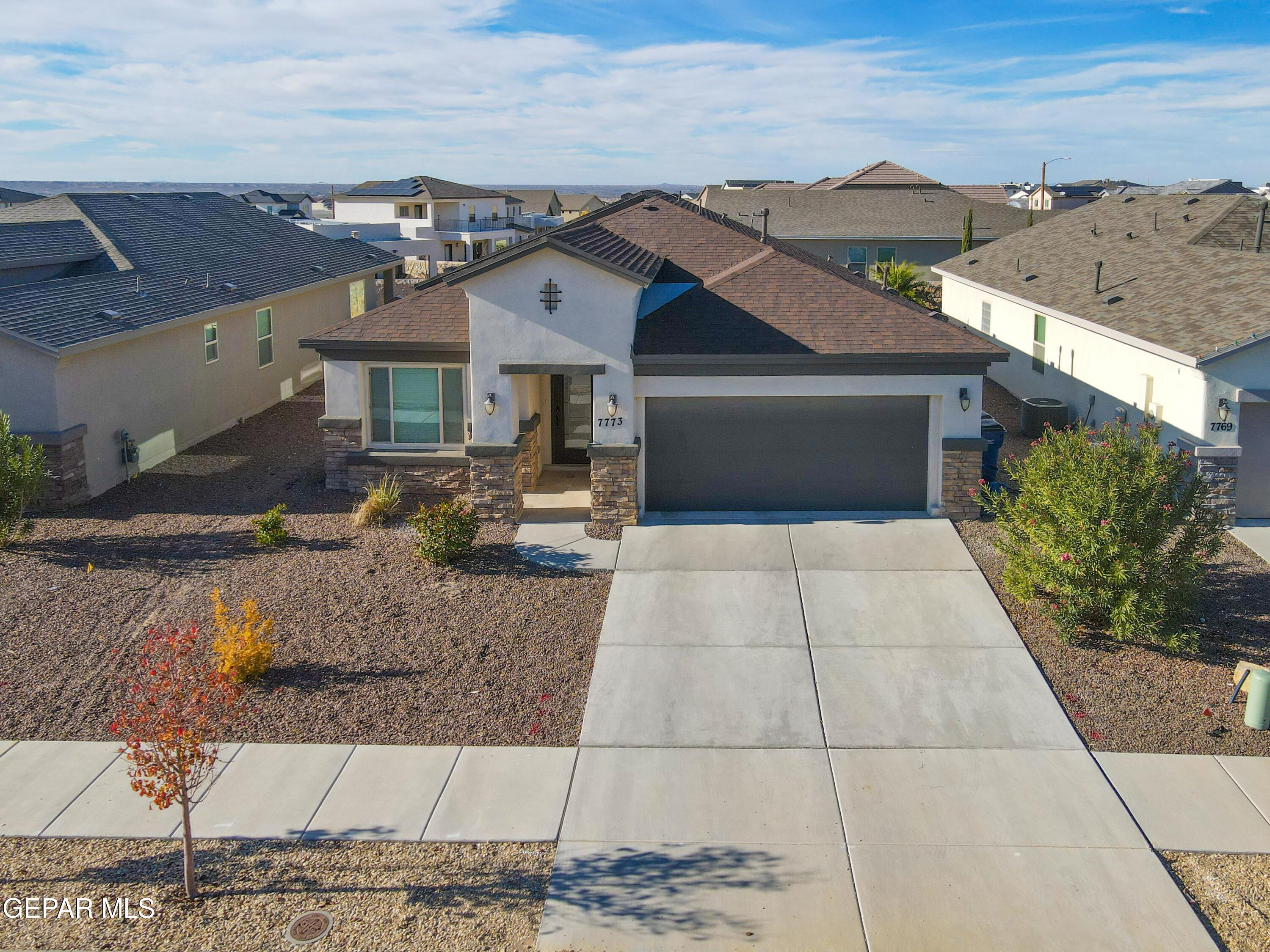 7773 Enchanted Ridge Drive El Paso, TX 79911 - Photo 1 of 1 a front view of a house with a yard