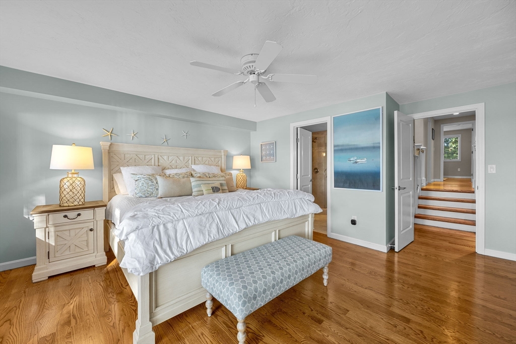 381 Great Oak Road, Unit 9 Mashpee, MA 02649 - Photo 20 of 42 a bedroom with a bed and wooden floor