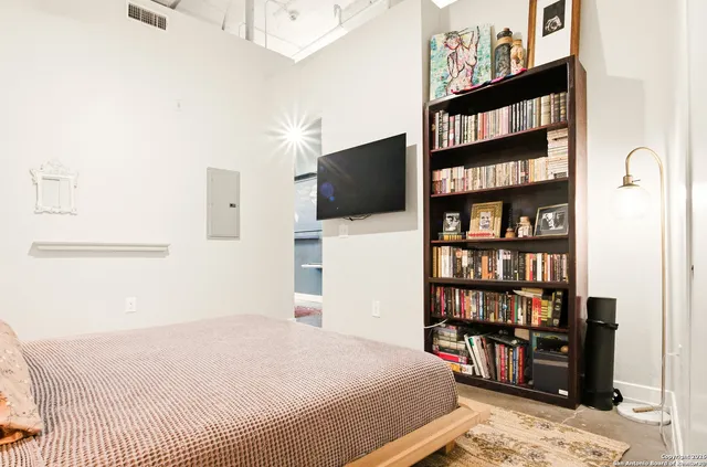 a bedroom with a bed and a book shelf
