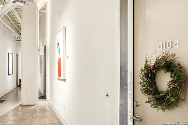 a view of a hallway with a potted plant