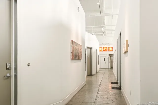 a street view with tall buildings and a big yard