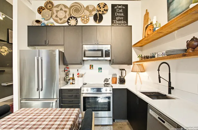 a kitchen with stainless steel appliances a stove and a refrigerator