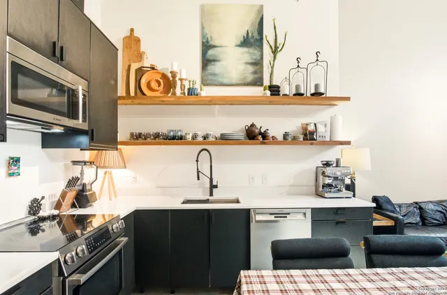 a kitchen with a sink and a stove top oven